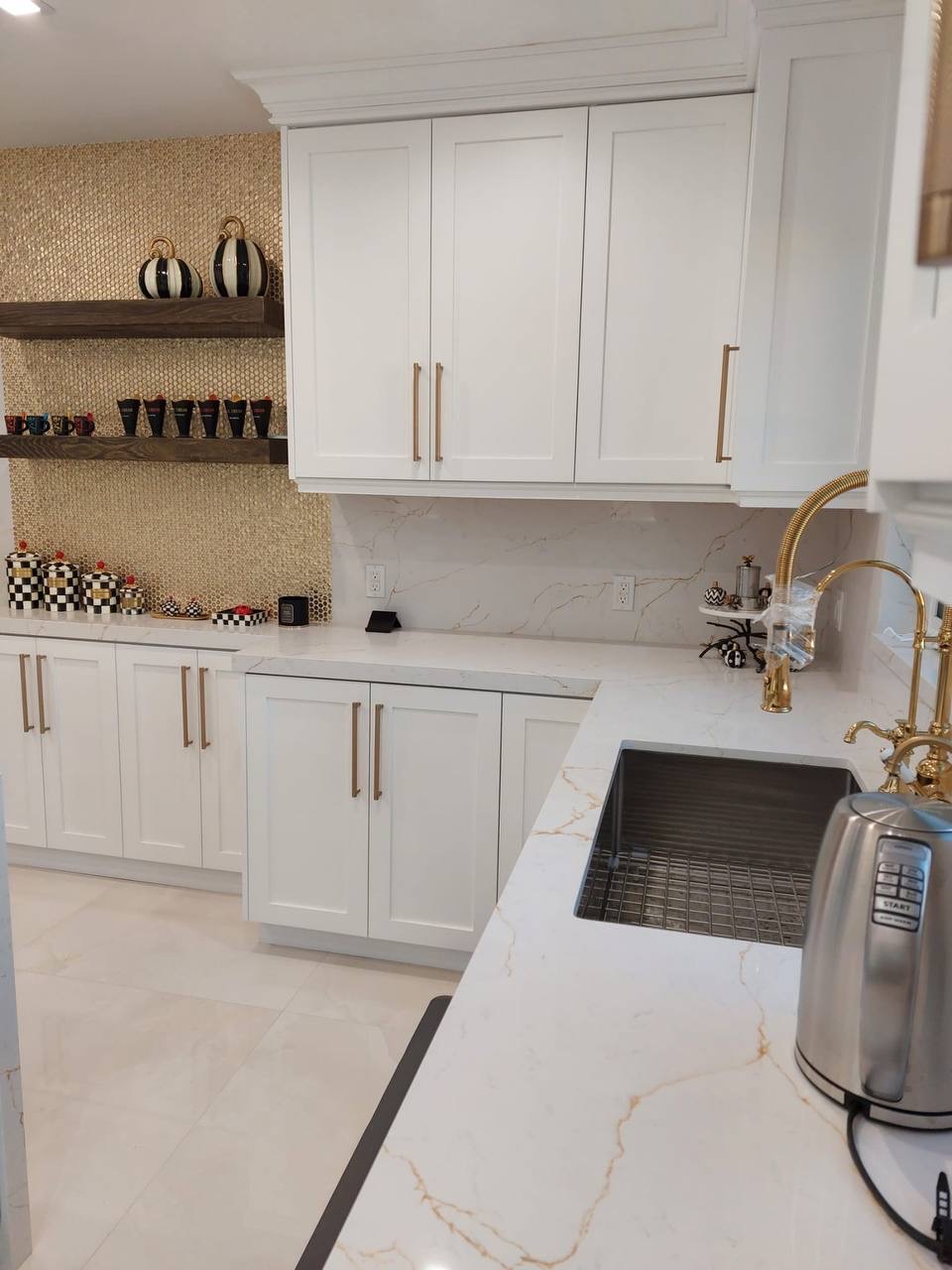 Custom white shaker kitchen with floating walnut shelves and calacatta gold quartz counters in Glendale CA