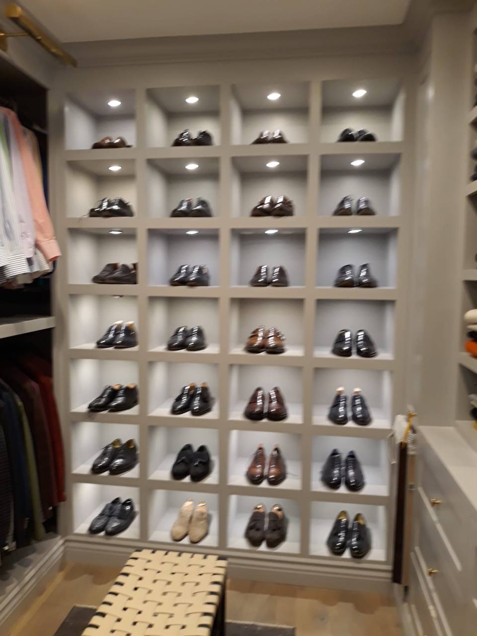 Custom walk-in closet shoe display wall with individually lit cubbies in a Glendale CA primary closet