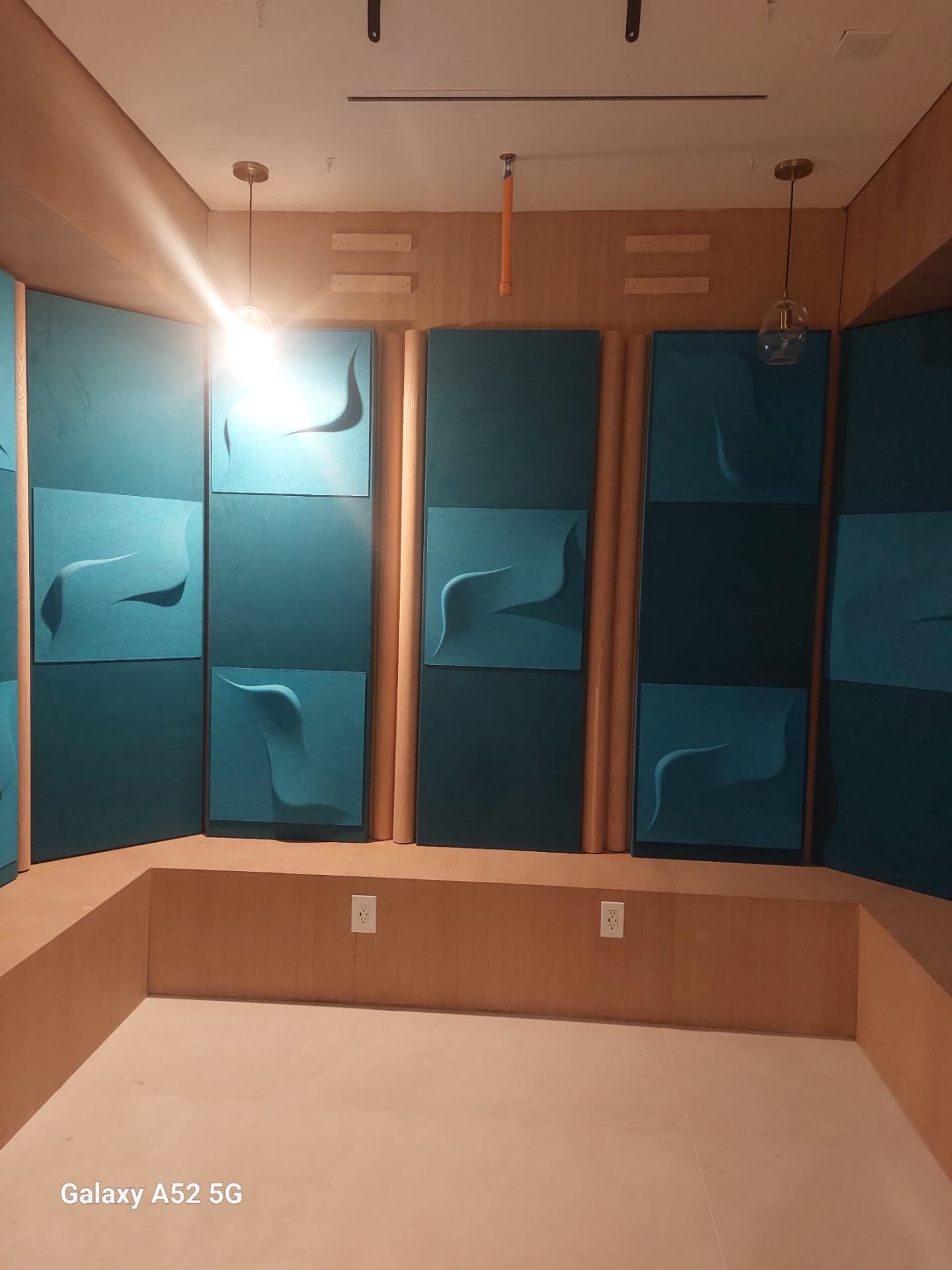 Custom media room built-ins with teal acoustic panels and white oak wood trim in a Glendale CA home