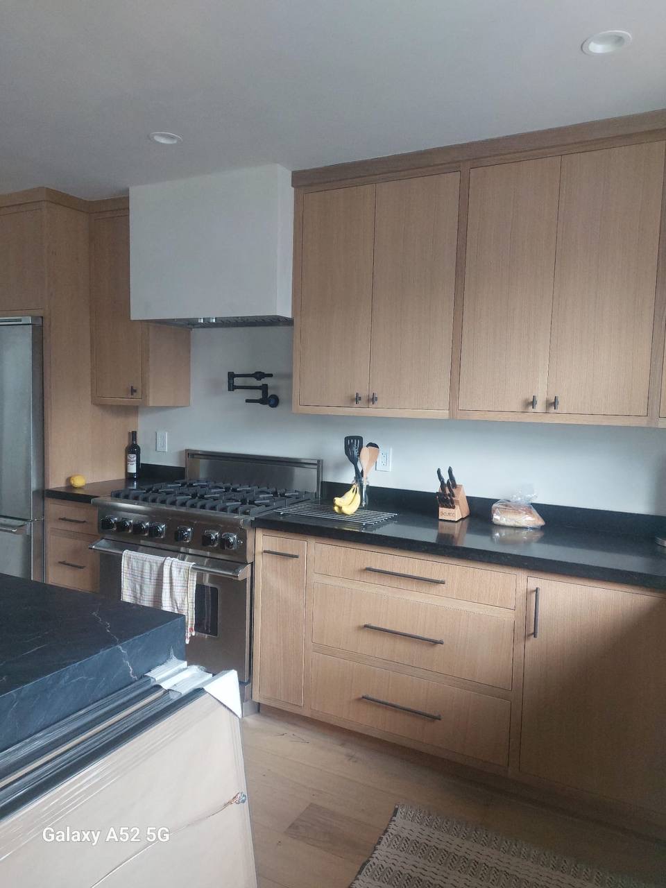 Custom white oak kitchen with soapstone island and plaster range hood in Glendale CA