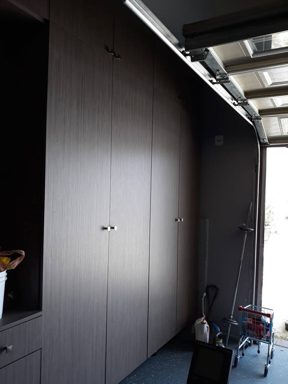 Custom gray melamine garage storage cabinets built floor-to-ceiling in a Glendale CA home