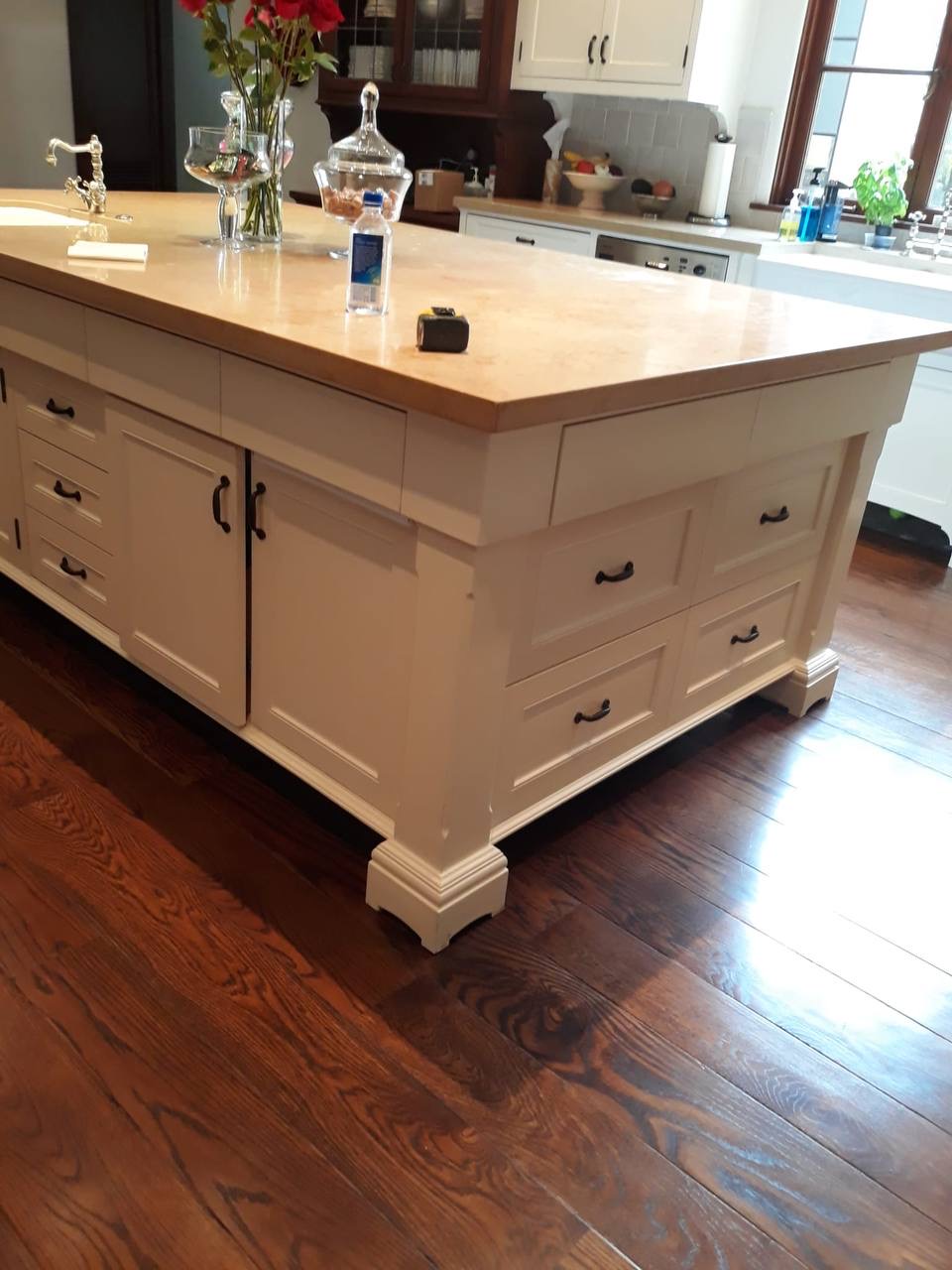 Custom oversized cream shaker kitchen island with butcher block top and corbel feet in Glendale CA