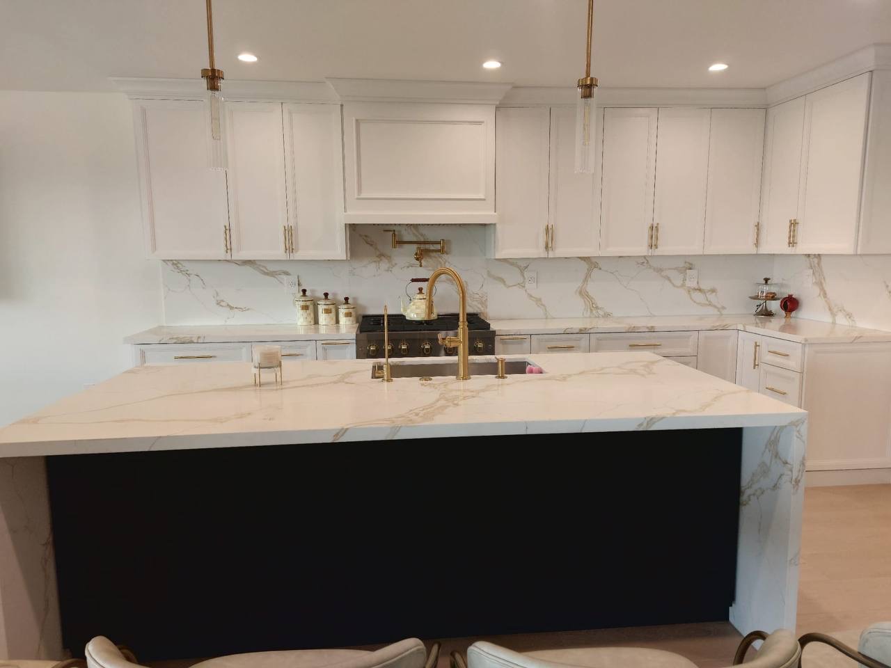 Custom white shaker kitchen with deep navy island and calacatta quartz waterfall counters in Glendale CA