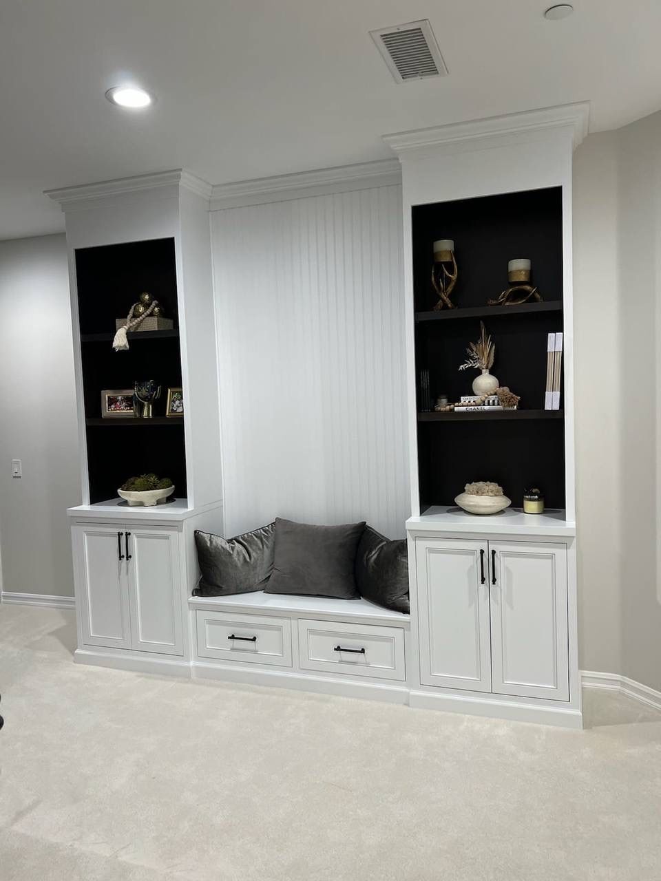 Custom white built-in bookshelves and cushioned window seat with shaker cabinets by JH Cabinetry in Glendale, CA