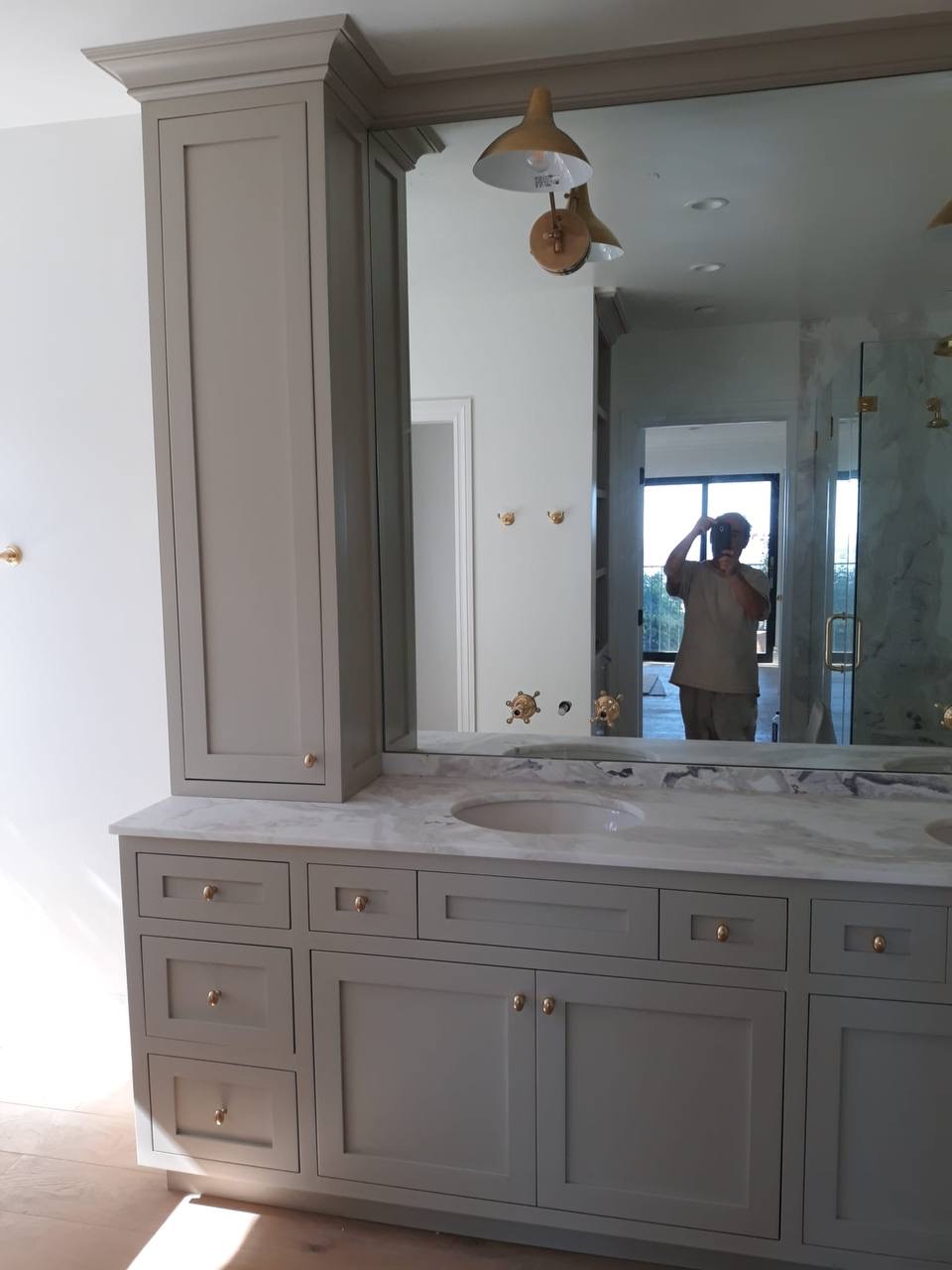 Custom gray master bath vanity with full-height storage tower and marble counter in Glendale CA