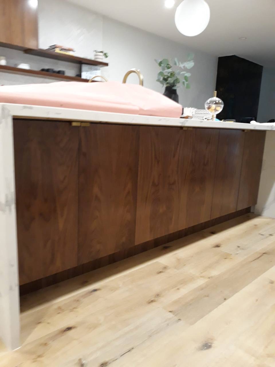 Custom walnut kitchen island with waterfall marble quartz counter and brass pulls in Glendale CA